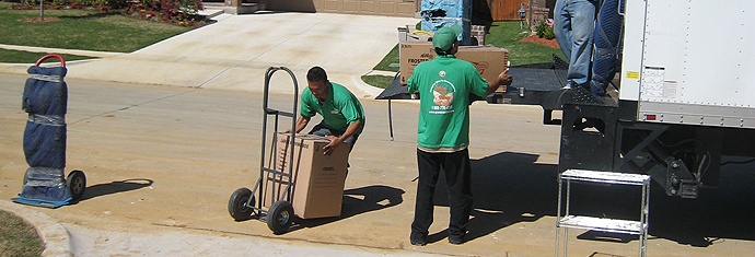 Green Van Lines movers working on a truck