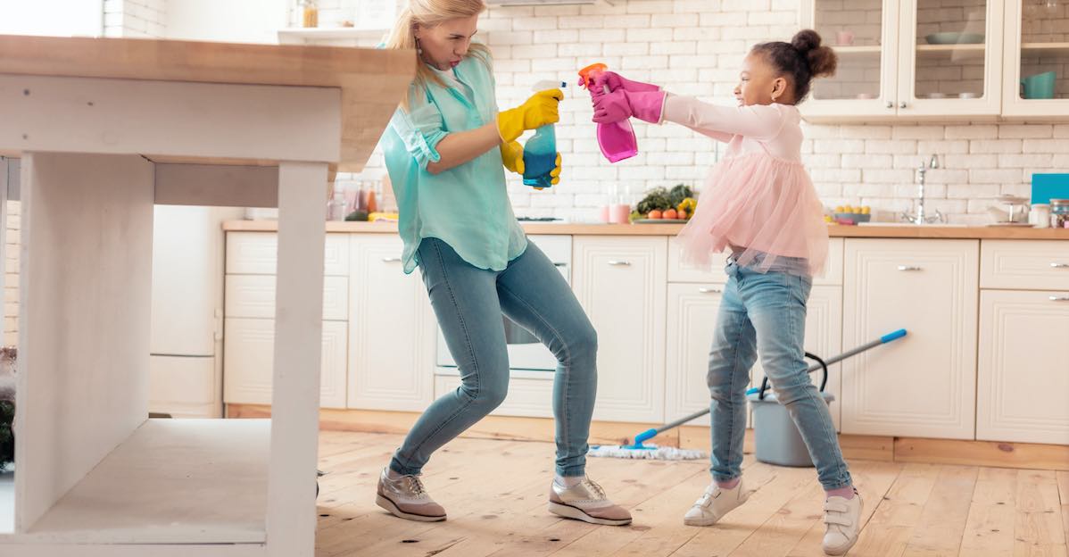 Mother and daughter with cleaning in the kitchen