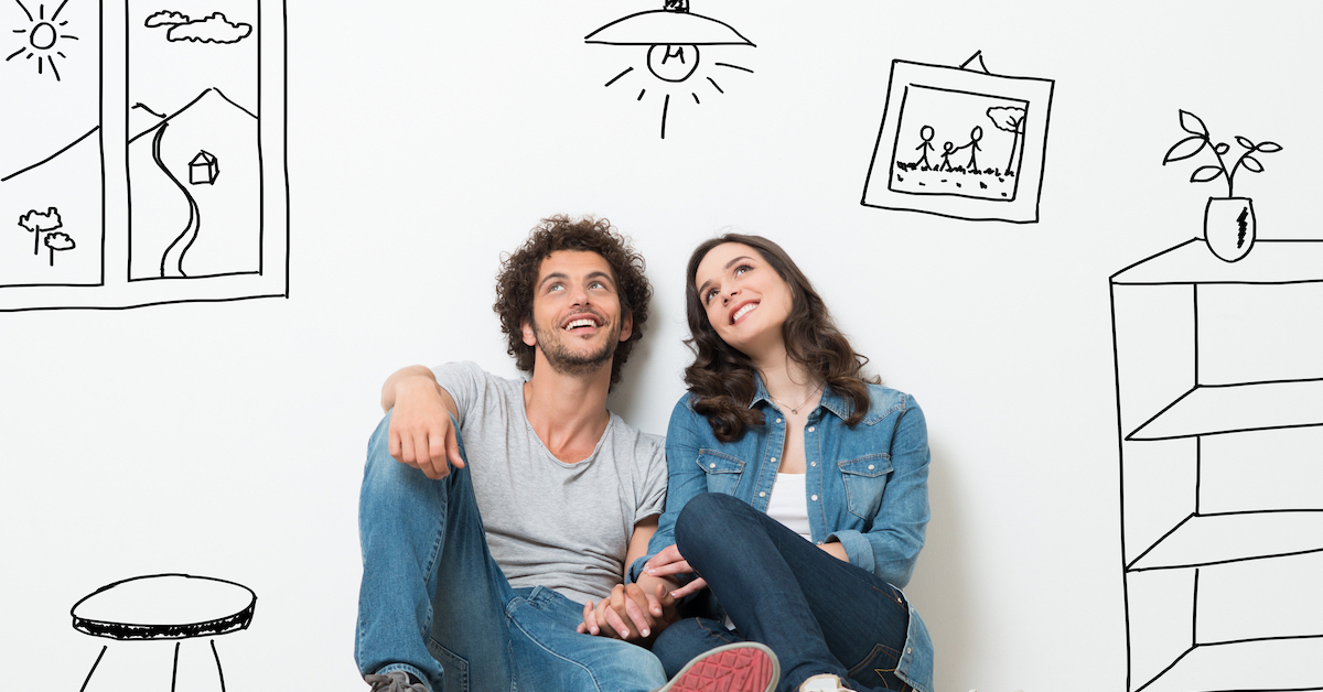 happy-couple-sitting-on-floor-dreaming-their-new-home 